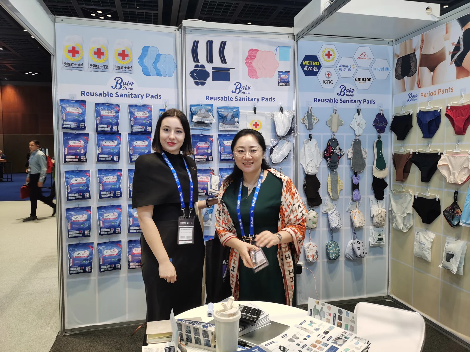 Two people at the Babyshow reusable care product display during a trade show